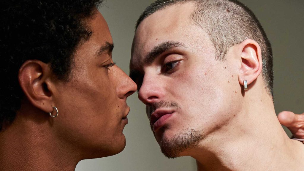 Queer intimacy film close-up of two men sharing a tense and intimate moment face to face