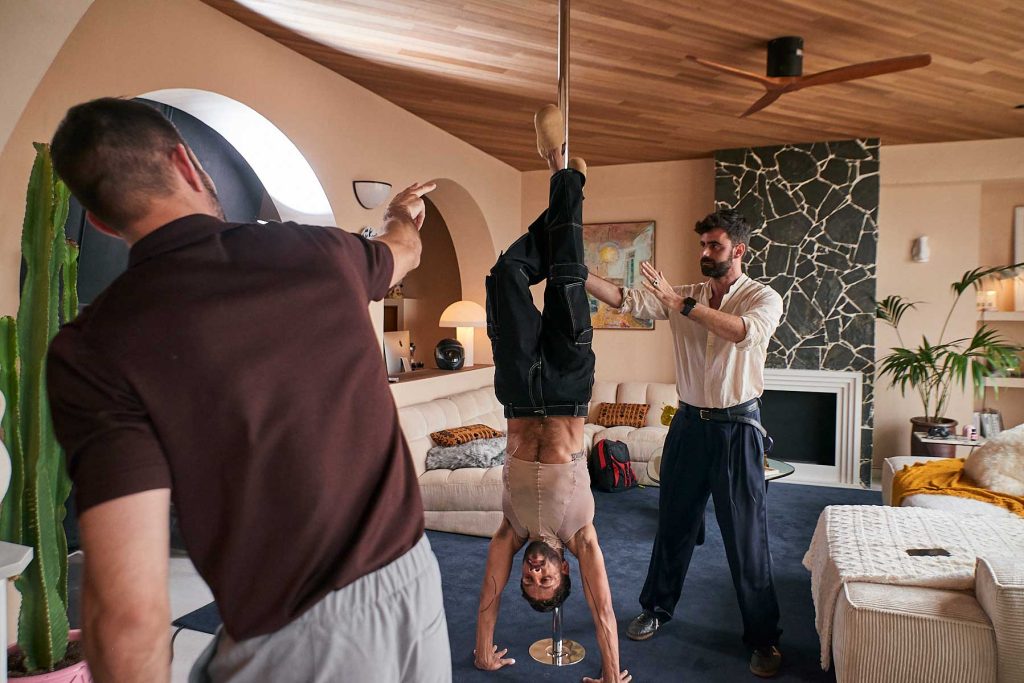 Queer cinema behind the scenes image of director and performers rehearsing choreography in a modern apartment set